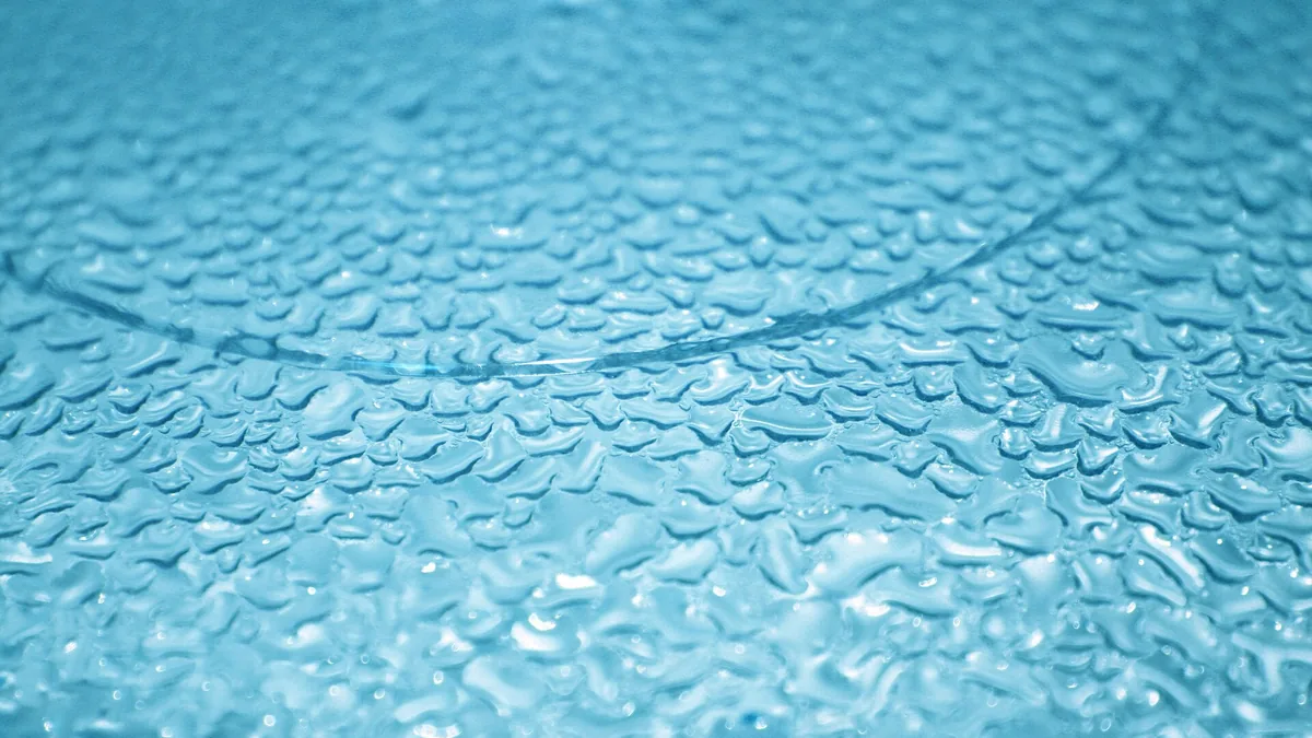 Water droplets on blue glass surface