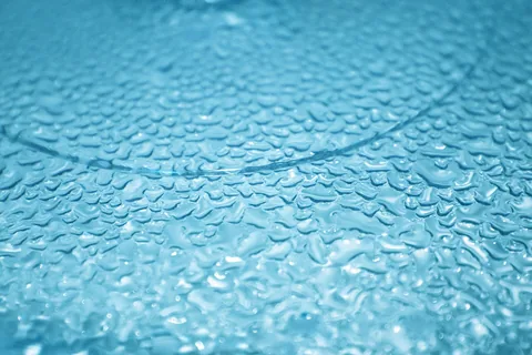 Water droplets on blue glass surface