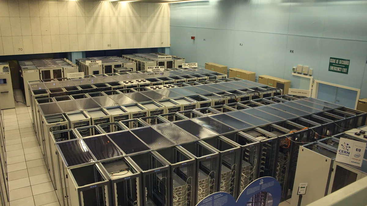 The CERN datacenter with World Wide Web and Mail servers. The rear of the equipment racks are exposed to the room, indicating cold aisle containment is being practiced